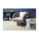 Clyde white geometric disc side table styled next to a grey velvet barrel armchair