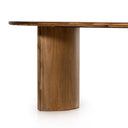Kiaan Oval 6 Seater Dining Table in natural wood finish styled with upholstered dining chairs, a bench, pendant lighting, and neutral decor.