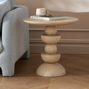 Mylo round natural wood end table with stacked geometric ball and bowl pedestal base styled in a room
