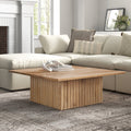 Davian square solid wood coffee table with fluted pedestal base in a bright living room