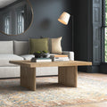 Lachlan square solid wood coffee table with woven rattan panel legs in a dark modern living room
