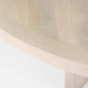 Close-up of the Loyal round dining table's tabletop edge and natural wood finish.