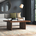 Lachlan square dark wood coffee table styled with a sectional sofa and floor lamp in a modern living room