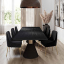 Skyler Solid Wood 8 Seater Dining Table in a natural finish styled with upholstered chairs in a bright dining room with large windows.