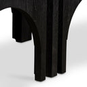 Close up side view of smaller charcoal black modular arched nested tables tucked under main Remi coffee table frame