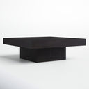 Uriah square black wood plinth coffee table three-quarter studio view showcasing recessed pedestal base