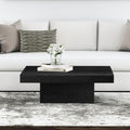Uriah square black wood block plinth coffee table with recessed base in a bright living room