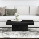 Uriah square black wood block plinth coffee table with recessed base in a bright living room
