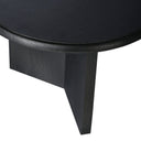 Close up angle view of Lee coffee table showing rounded tabletop edge and charcoal black wood grain legs