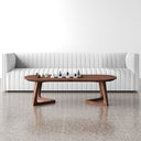 Donald oval walnut wood coffee table with angular cantilever bracket legs styled in a living room