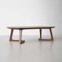 Donald oval walnut wood coffee table three-quarter studio view showcasing angular cantilever legs