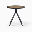 Cayden Side Table in a front three-quarter view, highlighting its natural wood grain, black tabletop rim, and tapered metal legs.