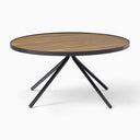Cayden Side Table shown alone against a white background with a round wood tabletop and four angled black legs.