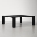 Axton square black wood coffee table three-quarter studio view showcasing chunky corner legs