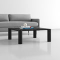 Axton square black wood coffee table with chunky rounded corner legs styled in a living room