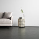 Alessandro light wood geometric line pattern cylinder drum end table styled next to a couch