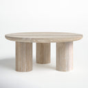 Rex round light wood coffee table three-quarter studio view showcasing chunky cylinder legs