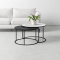 Damien Genuine Marble Coffee Table nesting set with white and black marble tops, displayed in front of a modern sofa.