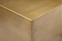 Macro view of Dante table corner showing brushed brass finish metal patina texture