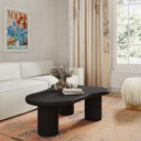 Reese black wood organic kidney shaped coffee table styled in a complete living room scene with an ivory sectional sofa