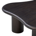 Close up angle view of Reese coffee table showing rounded tabletop edge and charcoal black wood grain cylinder leg