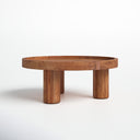 Dennis round natural wood tray top coffee table three-quarter studio view showcasing chunky cylinder legs