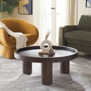 Dennis round dark brown wood tray top coffee table with chunky cylinder legs styled in a living room