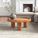 Dennis round natural wood tray top coffee table with chunky cylinder legs styled in a living room