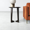 Gideon dark brown wood round end table with curved tripod legs styled next to a couch