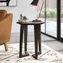 Gideon grey concrete round end table with curved tripod legs styled next to a couch