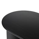 Close up angle view of Louie coffee table showing oval tabletop edge and natural black wood grain texture