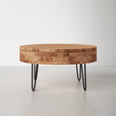 Keith round natural wood storage coffee table three-quarter studio view showcasing black hairpin legs