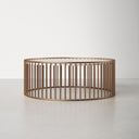 Zain round white marble drum coffee table side studio view showcasing gold slatted cage base