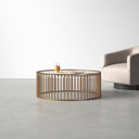 Zain round white marble drum coffee table with gold cage slatted base styled in a room