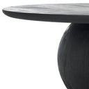 Close up angle view of Nixon coffee table showing tapered tabletop edge and black charcoal wood pedestal base