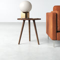 Jaden solid wood round end table with tapered tripod legs styled next to a couch