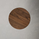 Top down view of Jaden round end table showing brown walnut wood grain surface