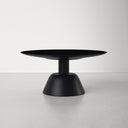 Boston round black wood coffee table low angle side studio view