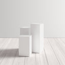 Karson 3 piece white minimalist pedestal nesting table set room view on light floors