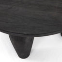 High angle close up view of Alberto black coffee table showing smooth tabletop surface texture and tapered leg joint