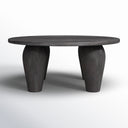 Alberto round black wood coffee table straight side view showing sculptural tapered tripod legs