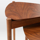 Close-up of Lewis Tripod Nesting Side Tables showing the black wood-grain tabletops, rounded corners, and slender cylindrical legs.