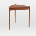 Lewis Tripod Nesting Side Table in black shown individually, highlighting its rounded tabletop, slim legs, and raised edge detail.