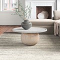 Cason round coffee table with white marble top and spherical wood ball pedestal base in a living room