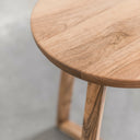 Macro view of Martin table edge showing light oak wood grain texture and tripod leg joint