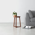 Martin solid wood round end table with tapered tripod legs styled next to a couch