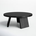 Landyn round black wood coffee table three-quarter studio view showcasing angled intersecting legs
