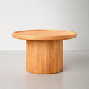 Paxton round wood pedestal coffee table alternative side view showing warm honey finish