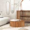 Sincere round wood drum coffee table with vertical fluted panel base styled in a living room