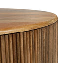 Close up angle view of Sincere coffee table top corner showcasing curved fluted base
